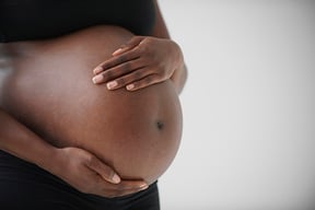 Woman holding her pregnant belly